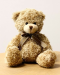 Ours en peluche beige avec nœud à carreaux